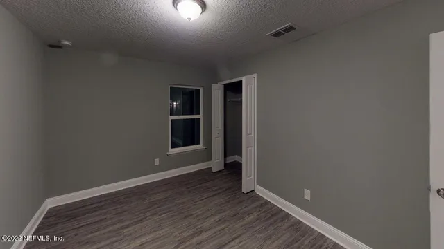 a view of room with window and hardwood floor