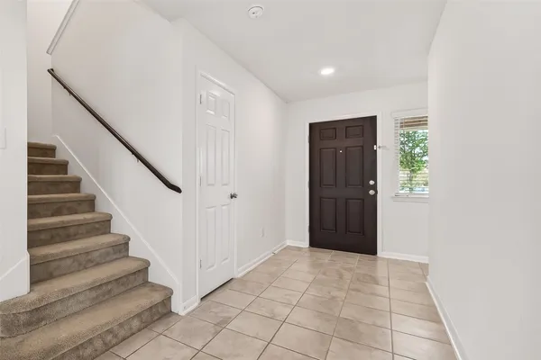 a kitchen with stainless steel appliances kitchen island granite countertop a refrigerator and a stove top oven