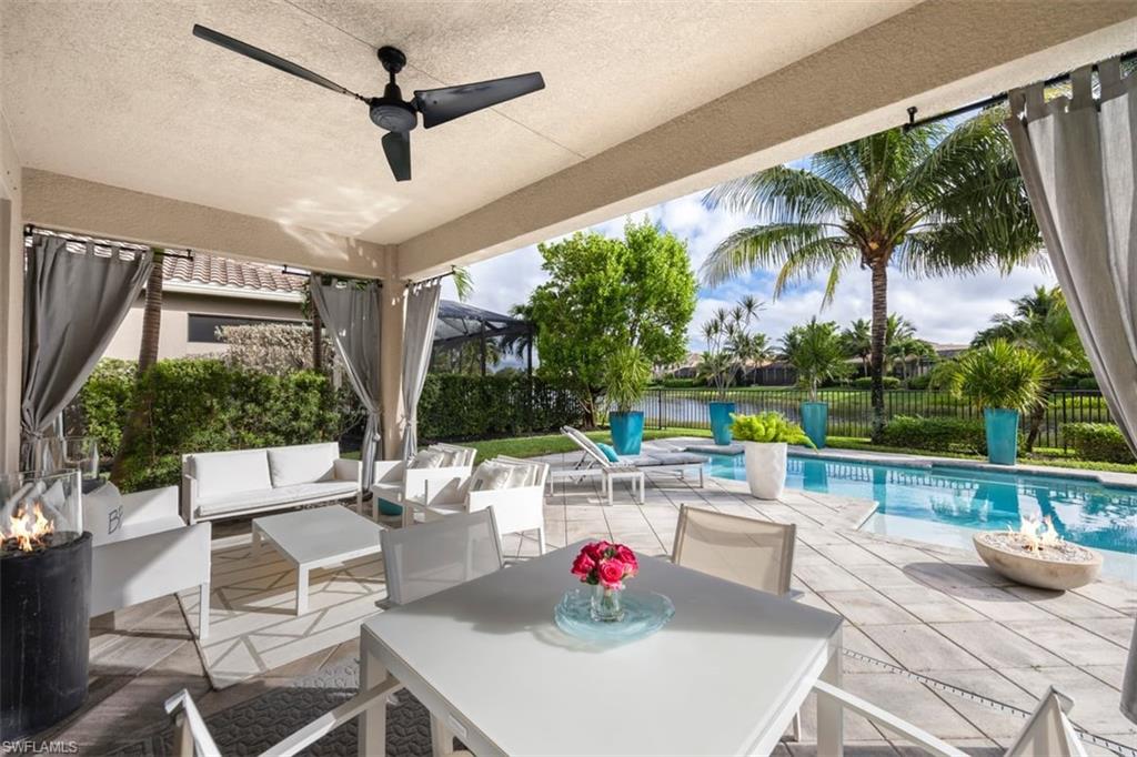 a living room with patio furniture and a floor to ceiling window