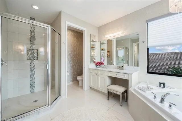 a bathroom with a tub sink shower and mirror