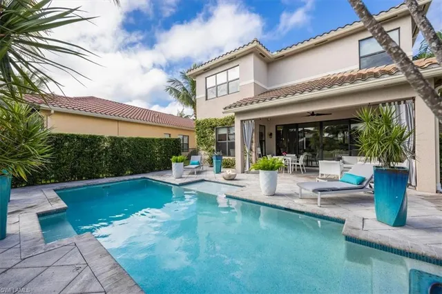 a view of a backyard with plants and patio