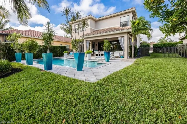 an aerial view of a house with a garden and lake view