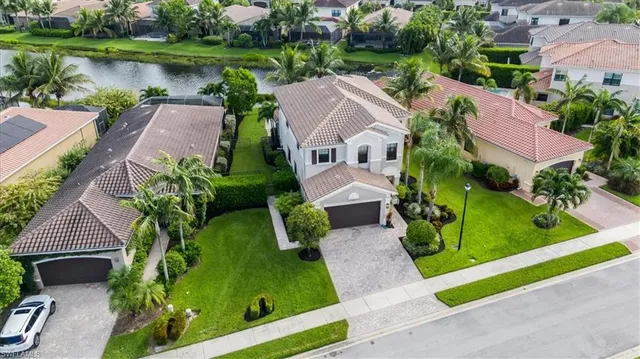 an aerial view of residential houses with outdoor space and river