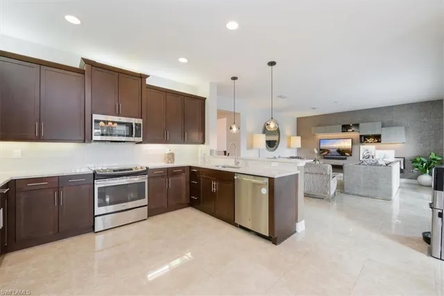 a kitchen with kitchen island granite countertop wooden cabinets and white appliances