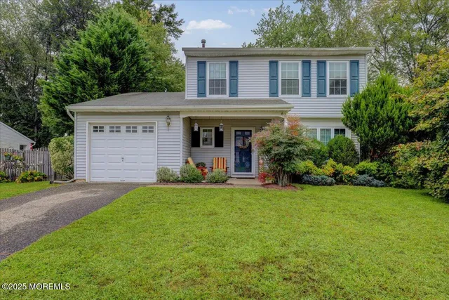 a view of a house with a yard and plants