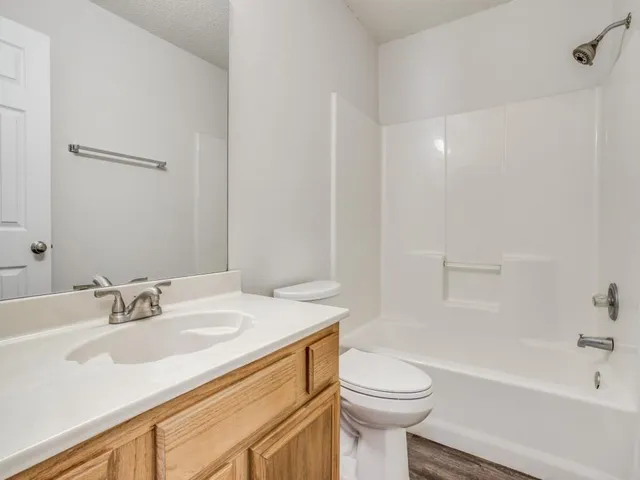 a bathroom with a sink a toilet and a bathtub