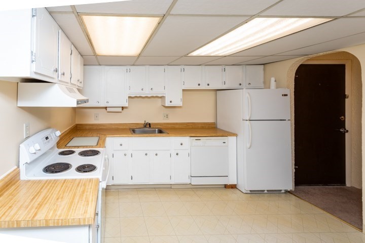 11 Shadowbrook Lane, Unit 9 Milford, MA 01757 - Photo 1 of 20 a kitchen with a refrigerator a stove and white cabinets