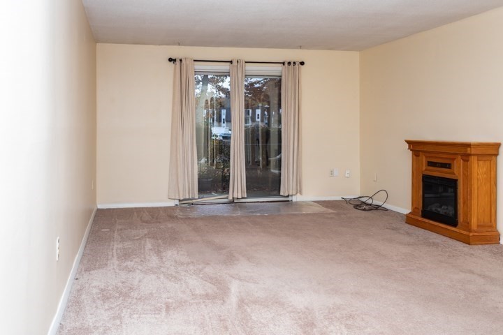11 Shadowbrook Lane, Unit 9 Milford, MA 01757 - Photo 2 of 20 an empty room with a fireplace