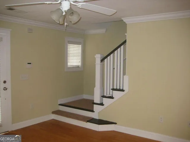 a view of entryway with stairs and wooden floor