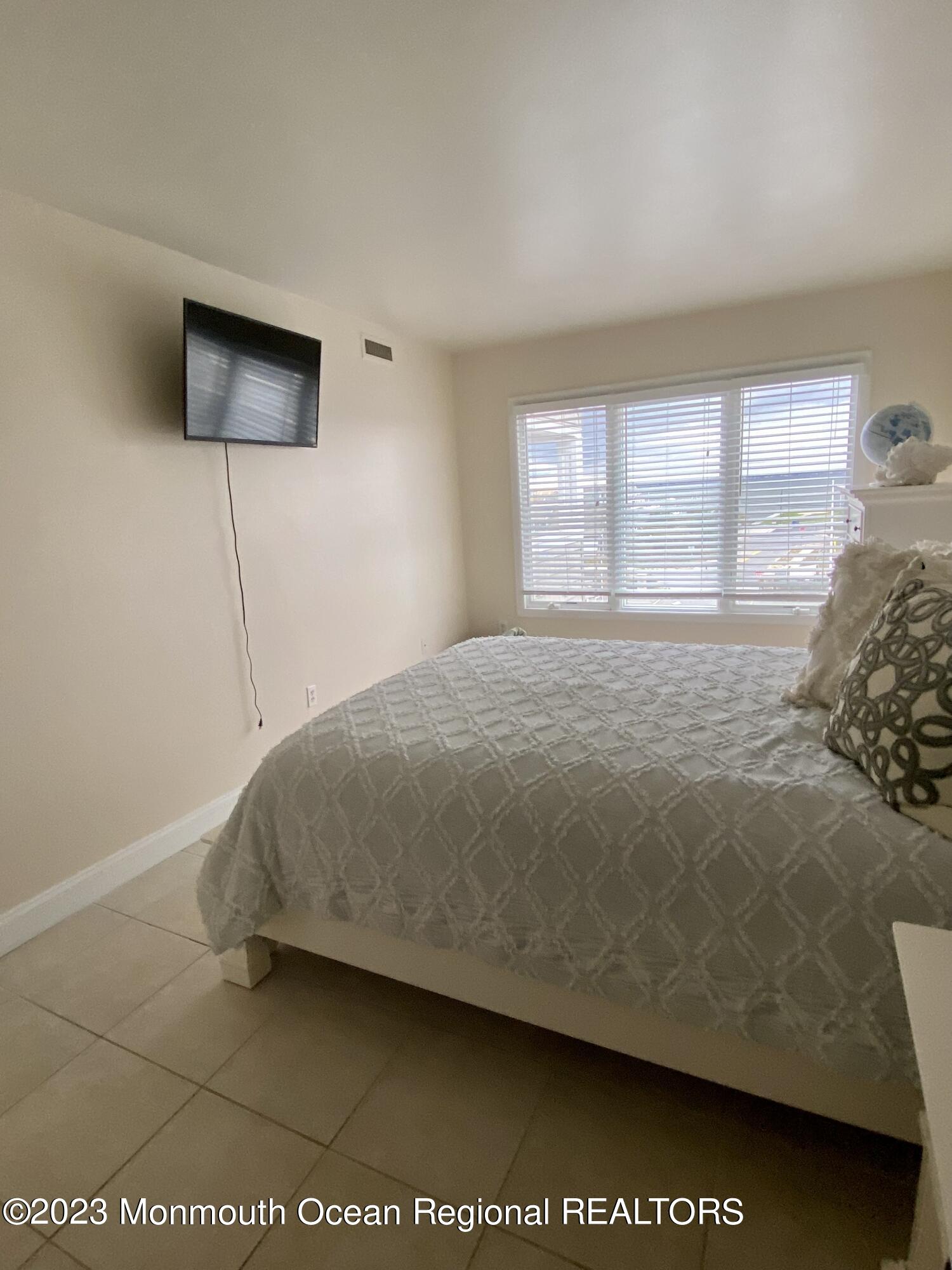438 Highway 35, Unit 5305 Mantoloking, NJ 08738 - Photo 13 of 19 a bedroom with a bed and a flat screen tv