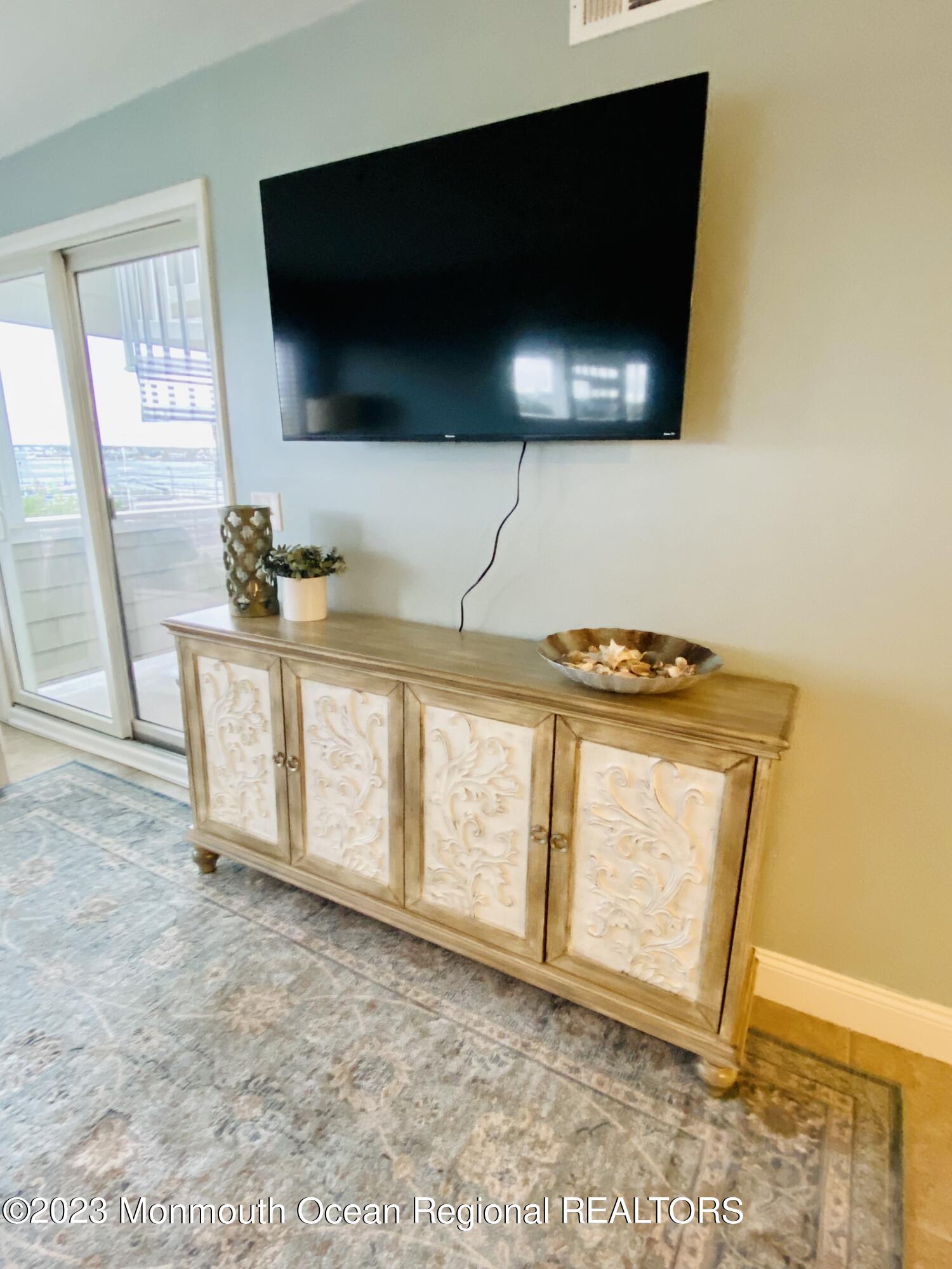438 Highway 35, Unit 5305 Mantoloking, NJ 08738 - Photo 18 of 19 a view of washer and flat screen tv