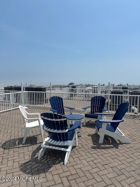 438 Highway 35, Unit 5305 Mantoloking, NJ 08738 - Photo 19 of 19 a roof deck with a table and chairs