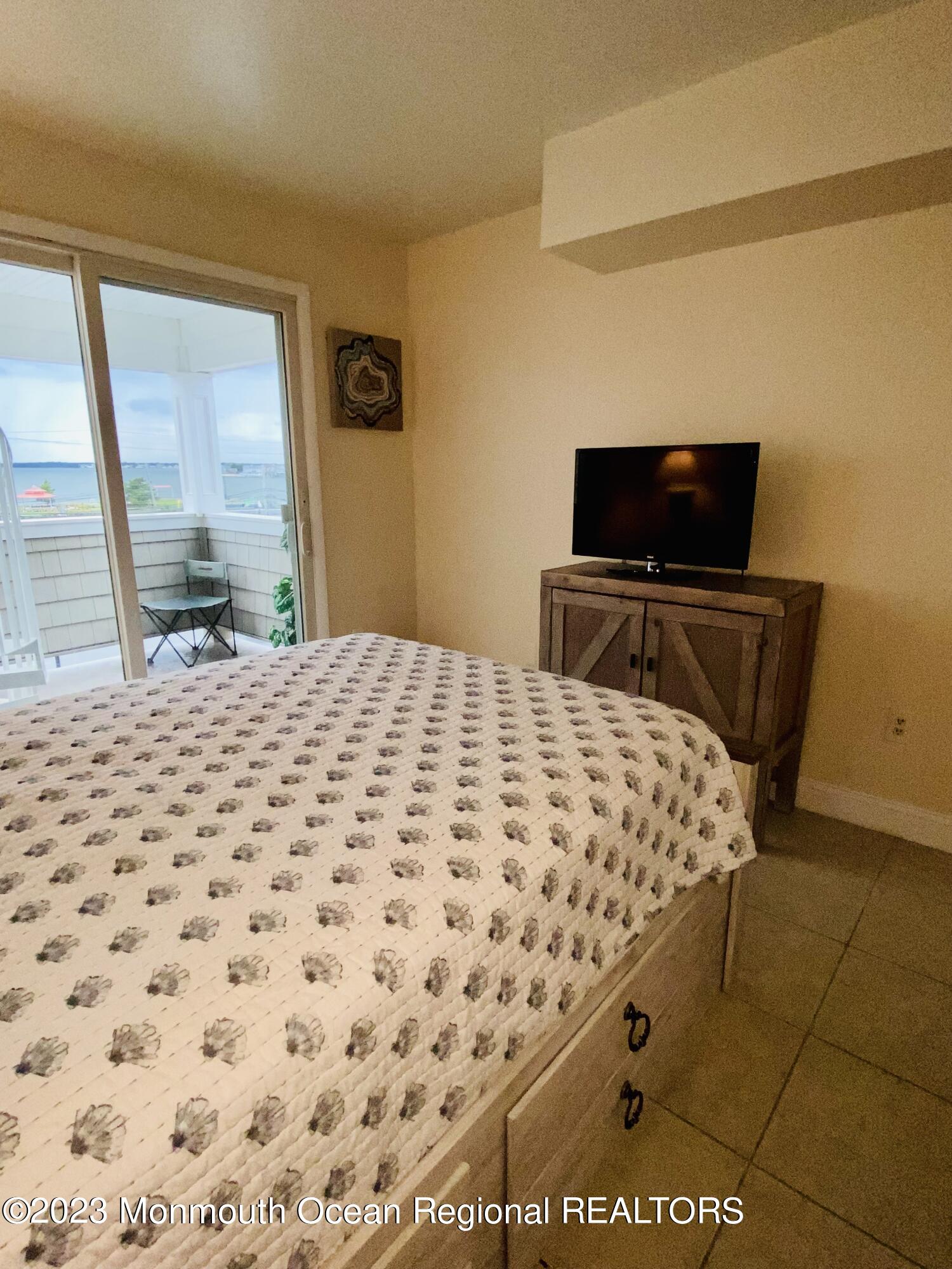 438 Highway 35, Unit 5305 Mantoloking, NJ 08738 - Photo 10 of 19 a bedroom with a bed and wooden floor