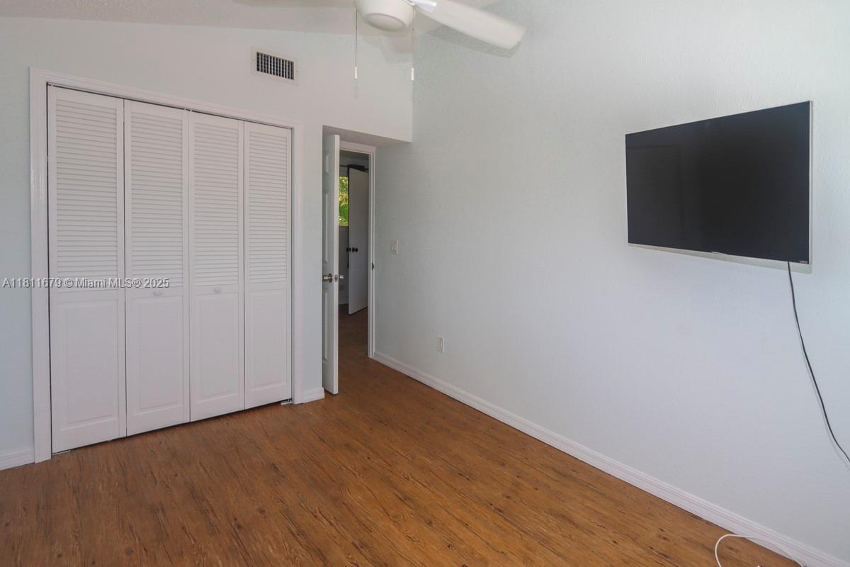812 Chukker Road, Unit 3 Delray Beach, FL 33483 - Photo 11 of 20 a view of a livingroom with wooden floor and cabinet