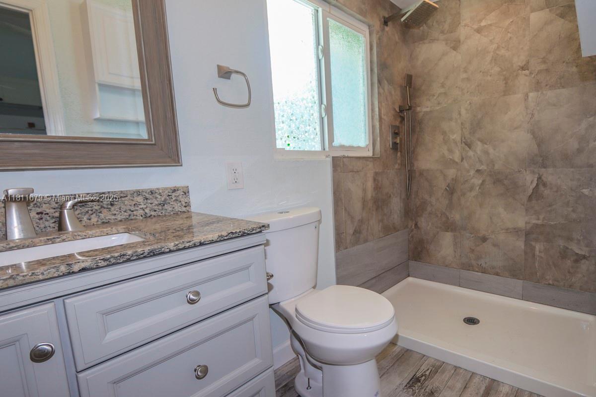 812 Chukker Road, Unit 3 Delray Beach, FL 33483 - Photo 7 of 20 a bathroom with a granite countertop toilet a sink and a bathtub