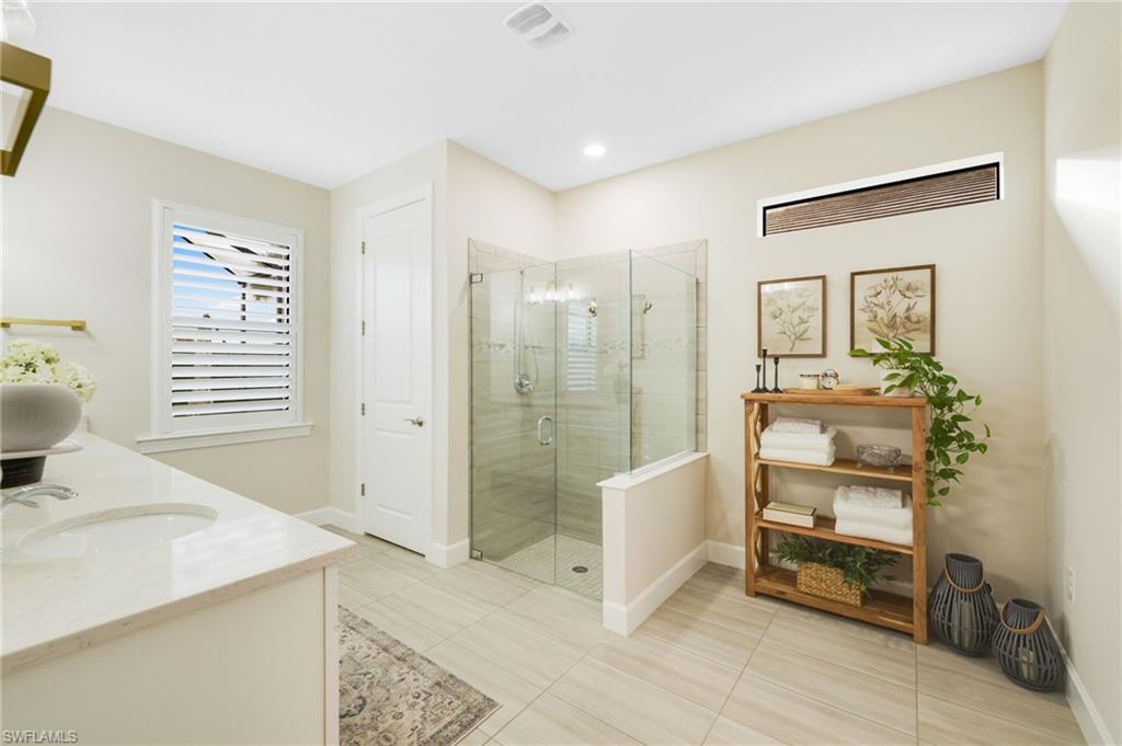 19837 Beverly Park Road Estero, FL 33928 - Photo 15 of 39 a spacious bathroom with a shower sink and mirror