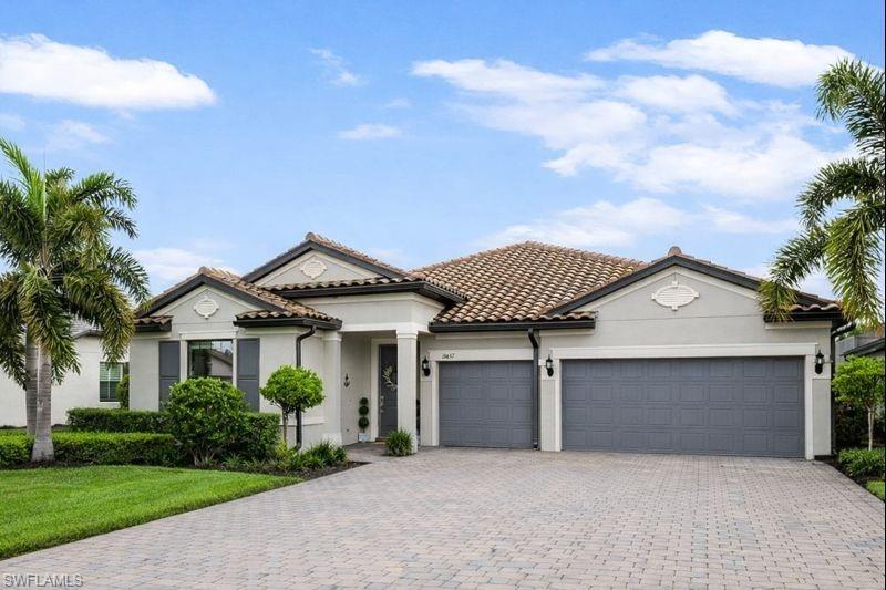 19837 Beverly Park Road Estero, FL 33928 - Photo 2 of 39 front view of a house with a garden
