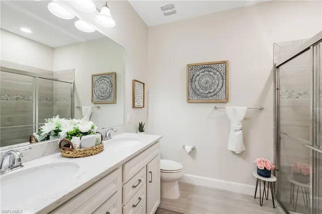 a living room with furniture a chandelier and a rug