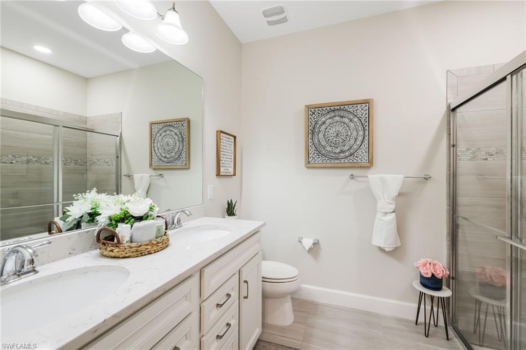 19837 Beverly Park Road Estero, FL 33928 - Photo 26 of 39 a bathroom with a sink mirror and toilet