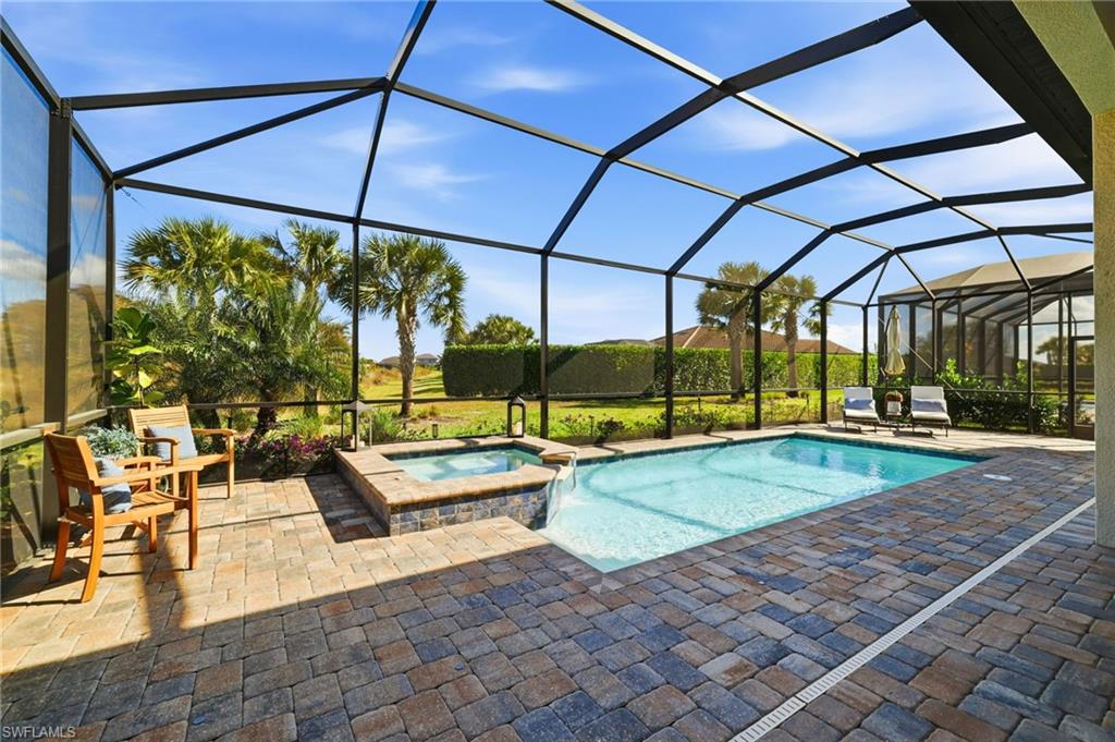 19837 Beverly Park Road Estero, FL 33928 - Photo 30 of 39 a view of swimming pool with chairs and tables