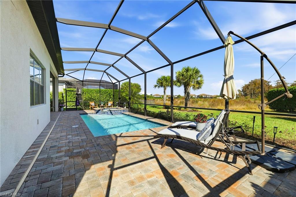 19837 Beverly Park Road Estero, FL 33928 - Photo 31 of 39 a view of a swimming pool with a patio