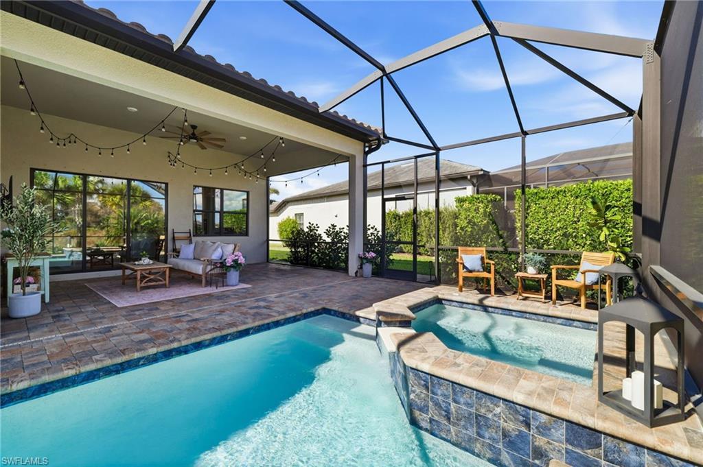 19837 Beverly Park Road Estero, FL 33928 - Photo 32 of 39 a living room with patio furniture and a garden