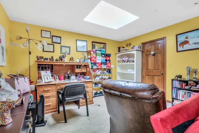 a room with furniture a air conditioner vent and a couch