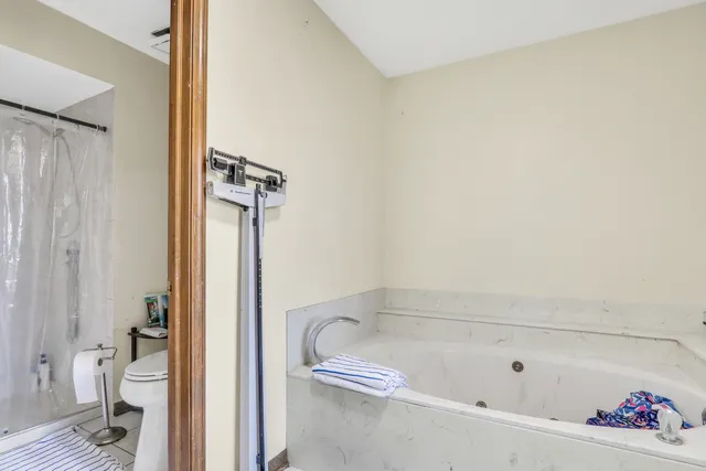 a bathroom with a tub and shower