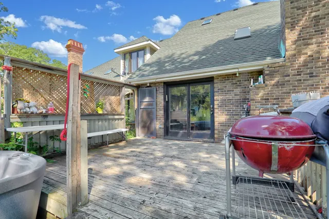 a view of a chair and table in backyard of the house