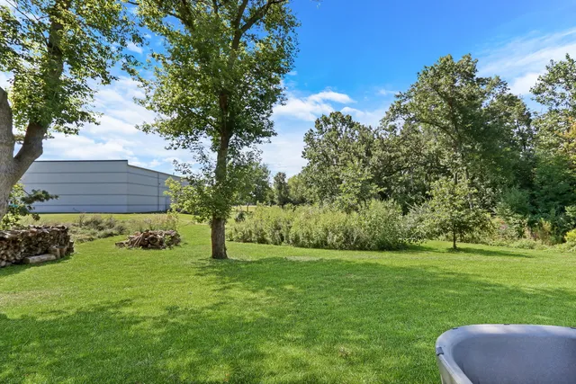 a view of an house with backyard space and garden