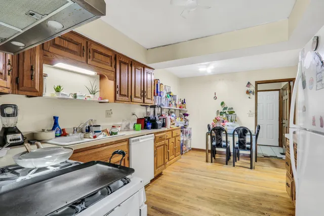 a kitchen with stainless steel appliances granite countertop a sink dishwasher and cabinets with wooden floor