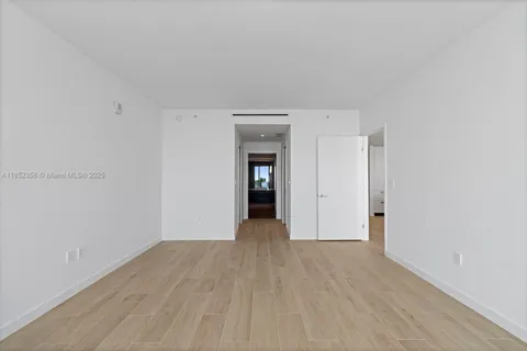 a view of a big room with wooden floor and a cabinet
