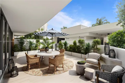 a view of a patio with couches and potted plants