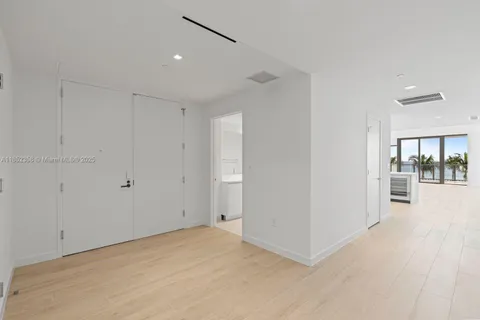 a large white kitchen with a sink and cabinets