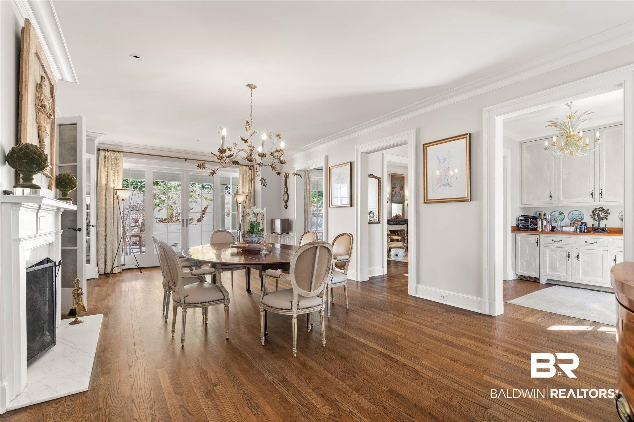 2256 De Leon Avenue Mobile, AL 36607 - Photo 10 of 61 Dining area with a chandelier, a high end fireplace, dark wood-style floors, and crown molding