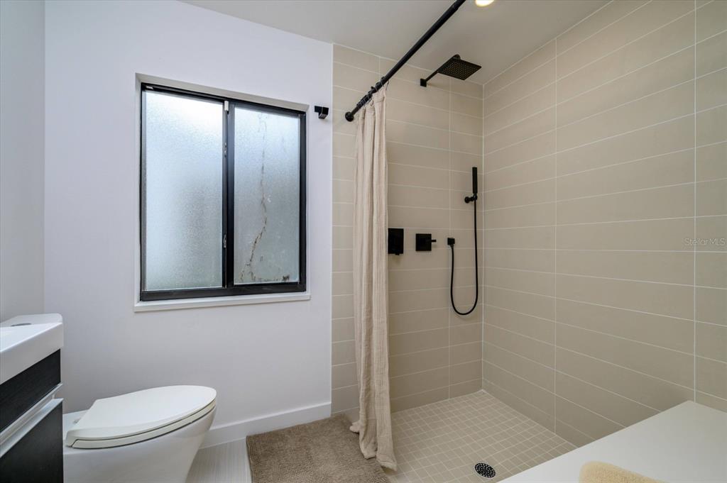 29318 Whippoorwill Lane Wesley Chapel, FL 33543 - Photo 20 of 38 a bathroom with a shower toilet and sink