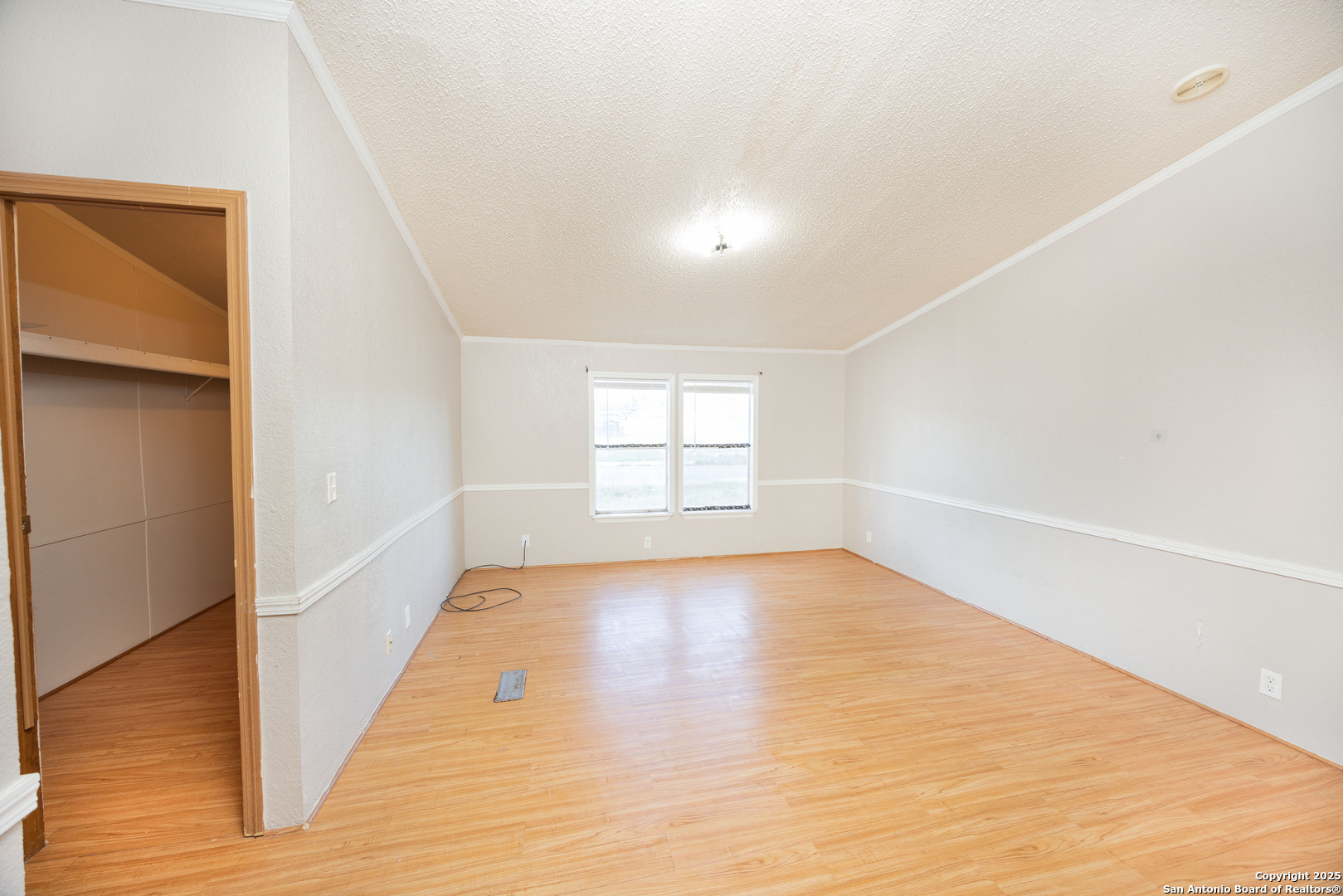 808 Uvalde Street Pleasanton, TX 78064 - Photo 11 of 25 a view of empty room with wooden floor and fan