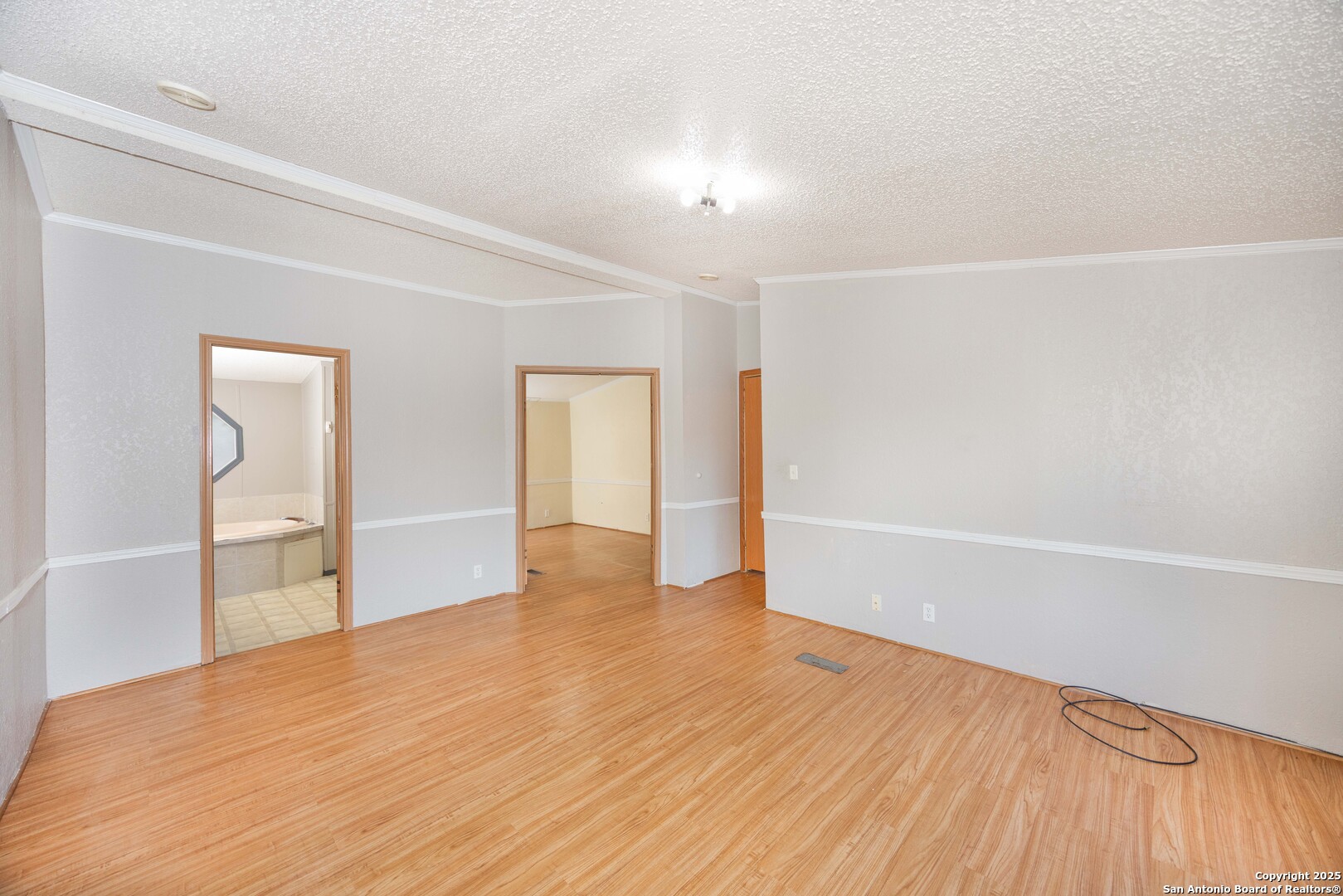 808 Uvalde Street Pleasanton, TX 78064 - Photo 12 of 25 a view of an empty room with wooden floor and closet