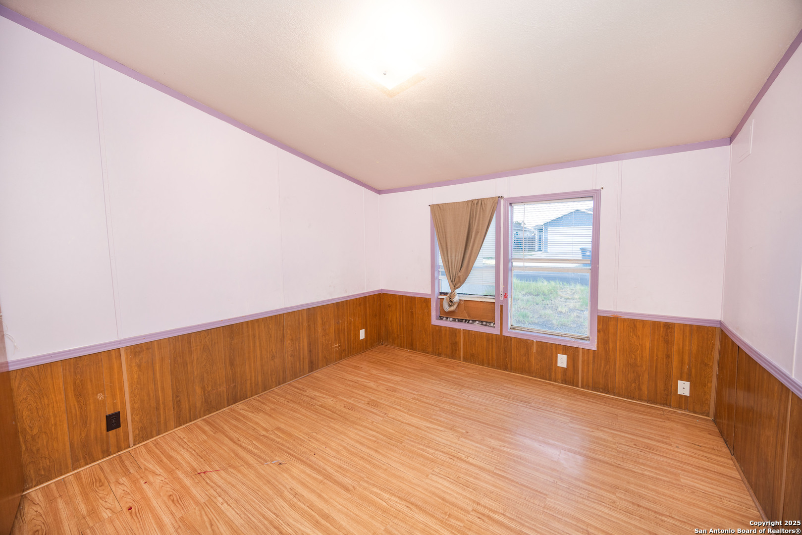 808 Uvalde Street Pleasanton, TX 78064 - Photo 15 of 25 a view of empty room with wooden floor and fan