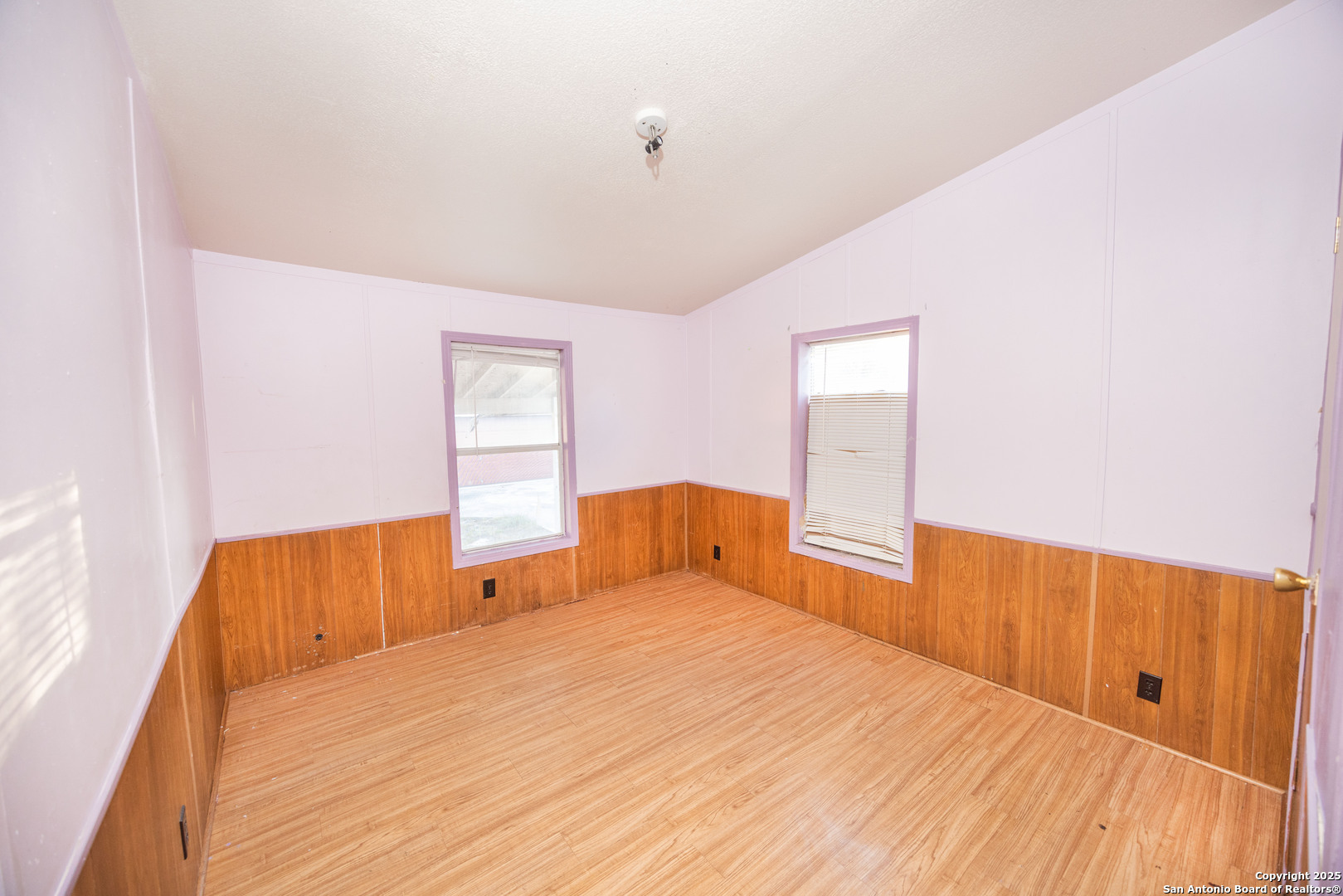 808 Uvalde Street Pleasanton, TX 78064 - Photo 16 of 25 a bedroom with a bed and wooden floor