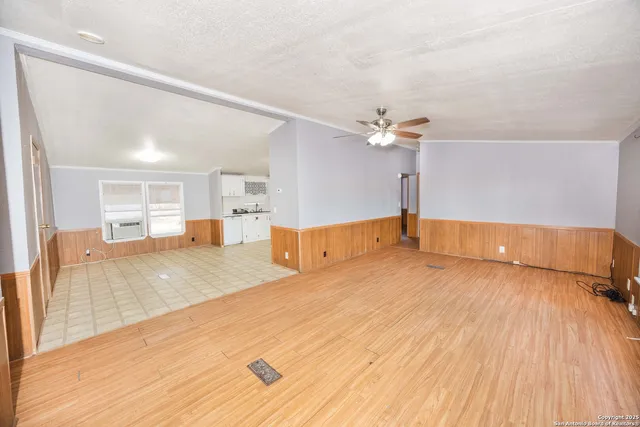 a view of a living room with wooden floor