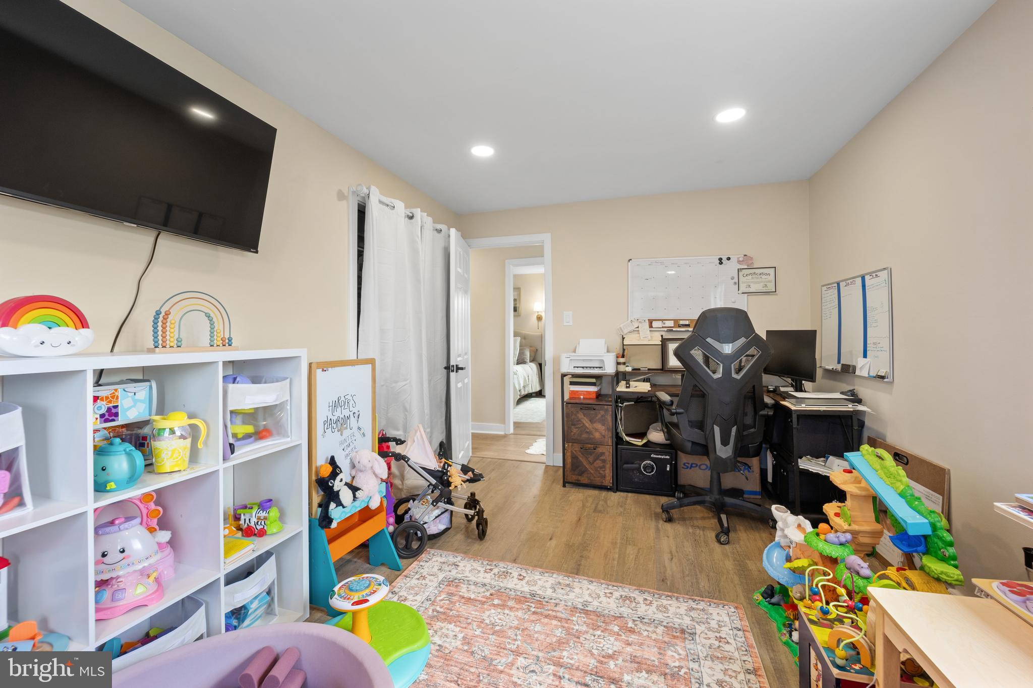 1012 Mearns Road Warminster, PA 18974 - Photo 20 of 28 a living room with furniture a baby crib and a wooden floor