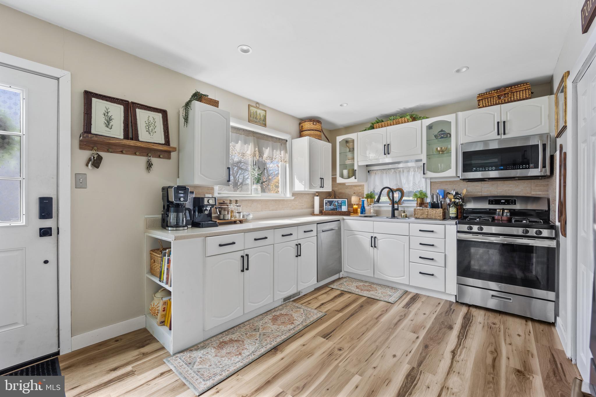 1012 Mearns Road Warminster, PA 18974 - Photo 7 of 28 a kitchen with stainless steel appliances granite countertop a stove a sink and a refrigerator