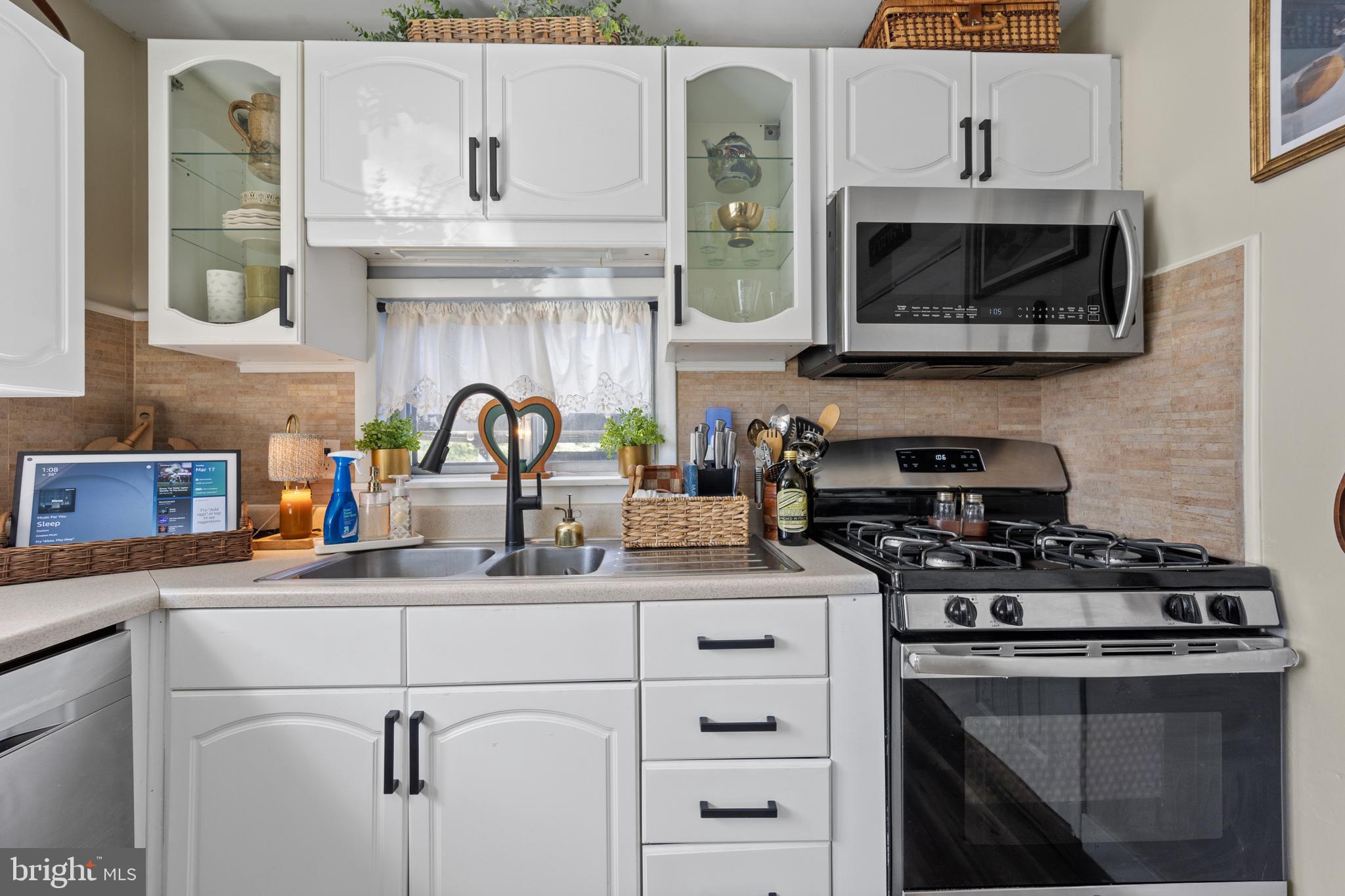 1012 Mearns Road Warminster, PA 18974 - Photo 8 of 28 a kitchen with stainless steel appliances granite countertop a sink a stove a microwave and wooden cabinets