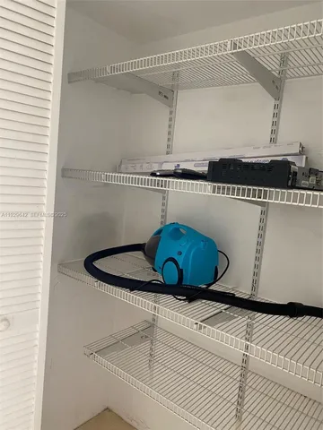 a kitchen with granite countertop a sink stove and microwave