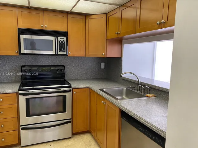 a kitchen with a refrigerator stove and a sink