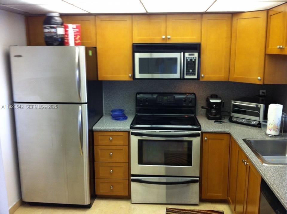 555 Northeast 15th Street, Unit 14K Miami, FL 33132 - Photo 18 of 47 a kitchen with a refrigerator stove and a sink
