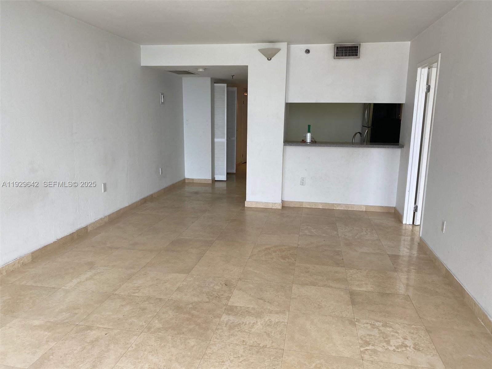 555 Northeast 15th Street, Unit 14K Miami, FL 33132 - Photo 22 of 47 an empty room with a cabinet and mirrors