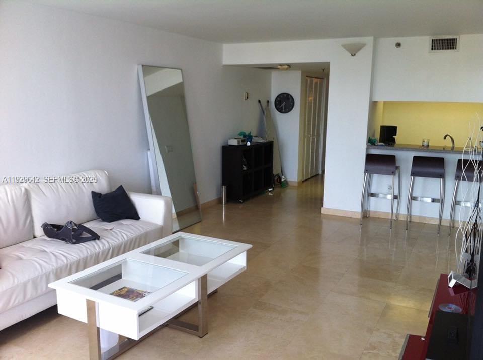 555 Northeast 15th Street, Unit 14K Miami, FL 33132 - Photo 33 of 47 a living room with furniture and a flat screen tv