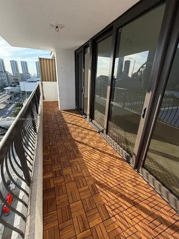 a living room with patio furniture and a floor to ceiling window